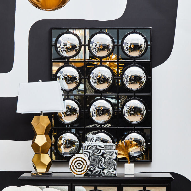 Decorative console table with mirror ball design in a stylish room.