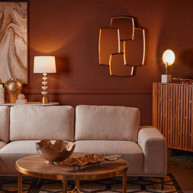 Living room with beige sofa, wooden coffee table, and decorative wall art.