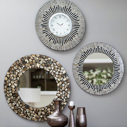 Three decorative mirrors on a gray wall with a wooden console table below.