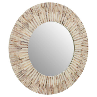 Round mirror with a decorative, sunburst frame made of natural materials on a white background