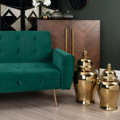 Modern interior with a green sofa, wooden cabinet, and decorative items.