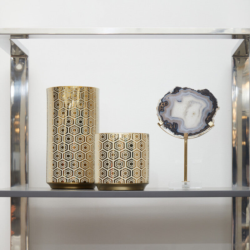 Decorative vases with geometric patterns on a shelf