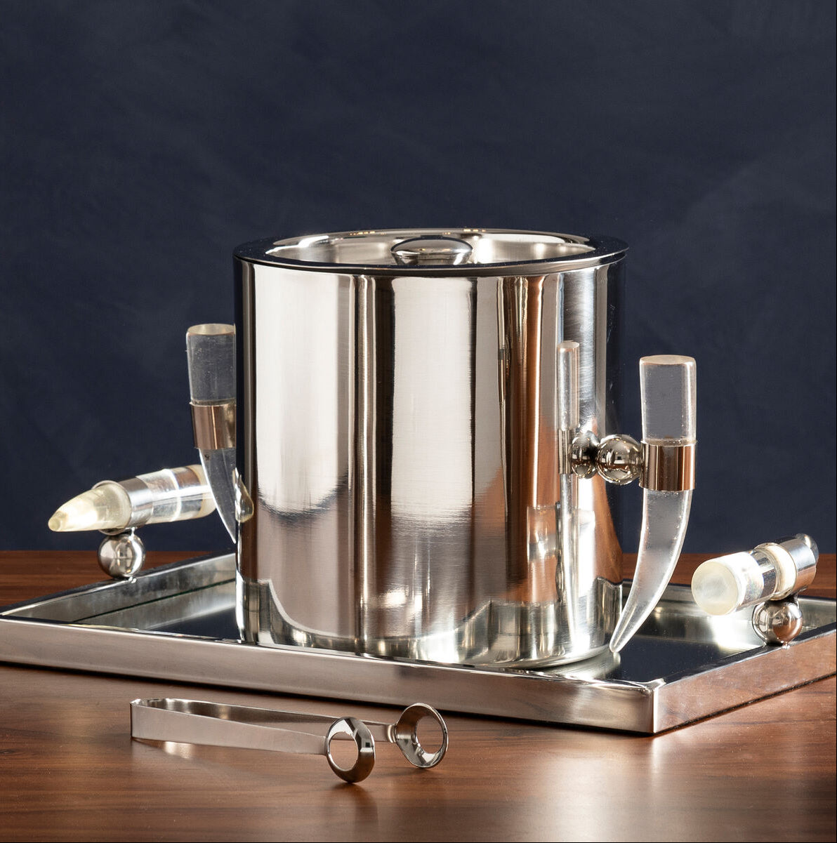 Silver ice bucket with handles on a dark background