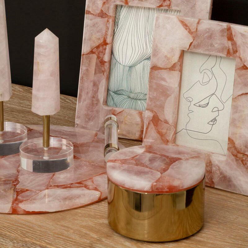 Marble-framed artwork on a wooden surface with decorative items.