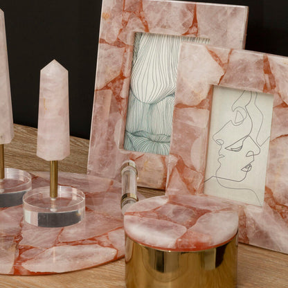 Marble-framed artwork on a wooden surface with decorative items.