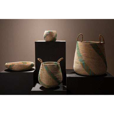 Set of woven baskets with green and beige patterns on a dark surface.