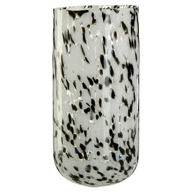 Tall glass vase with black speckles on a white background
