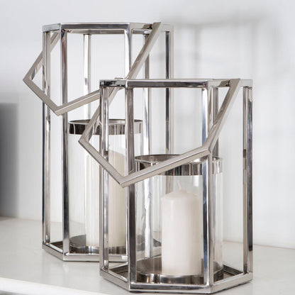 Decorative metal lantern with geometric design on a white surface