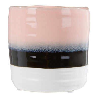 Ceramic tumbler with gradient color from pink to blue to black on a white background