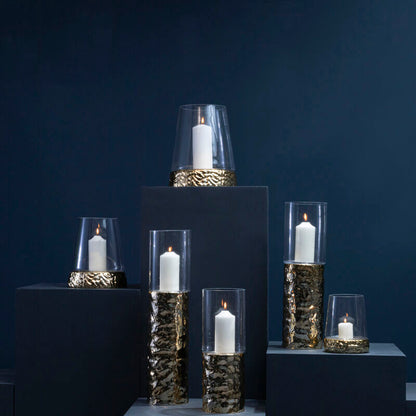 Set of candle holders with candles on a dark blue background