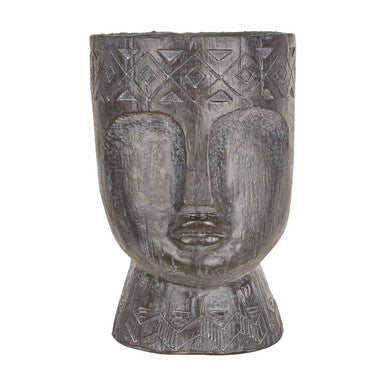 Decorative pot shaped like a face with geometric patterns on a white background