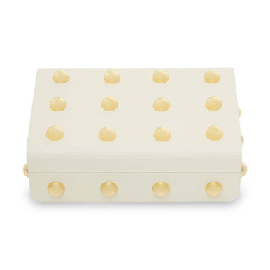 Cream-colored clutch with gold polka dots on a white background