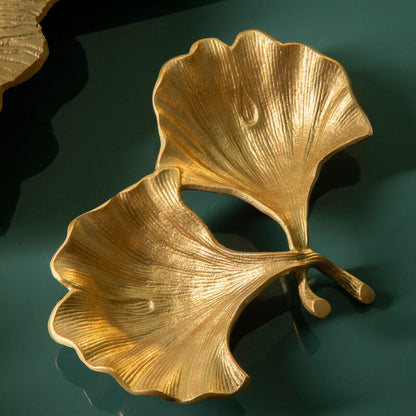 Gold leaf-shaped decorative item on a green surface