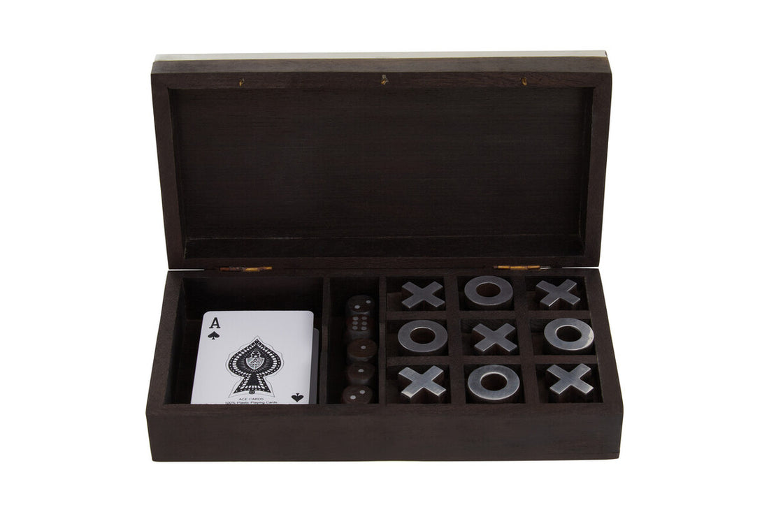 Wooden box with playing cards and game pieces on a white background