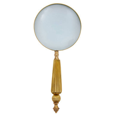 Handheld magnifying glass with gold handle on a white background