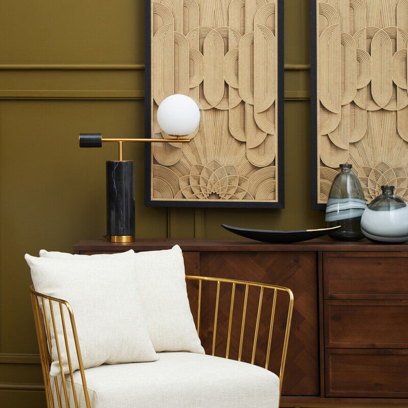 Modern interior with a white armchair, wooden sideboard, and decorative wall art.