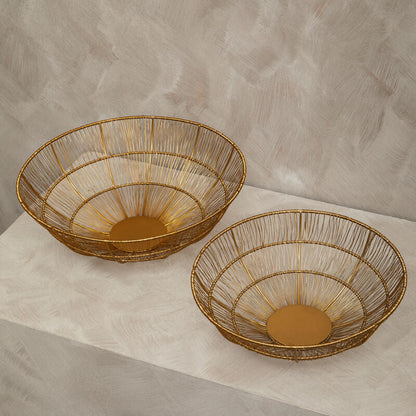 Two woven baskets on a textured surface with a neutral background