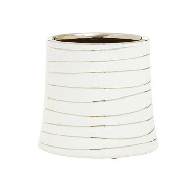 White cylindrical vase with ribbed texture on a white background