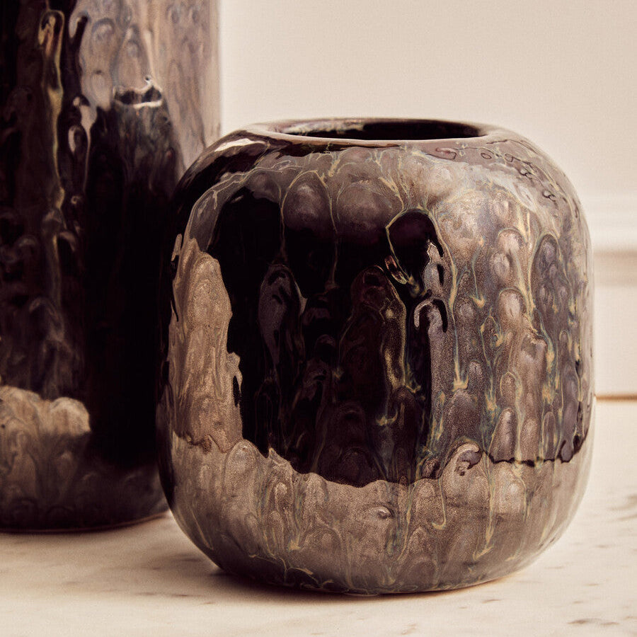 Decorative ceramic pot with intricate patterns on a light background