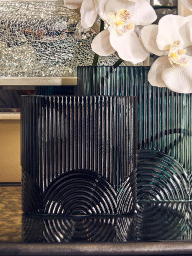 Decorative vase with white flowers on a reflective surface