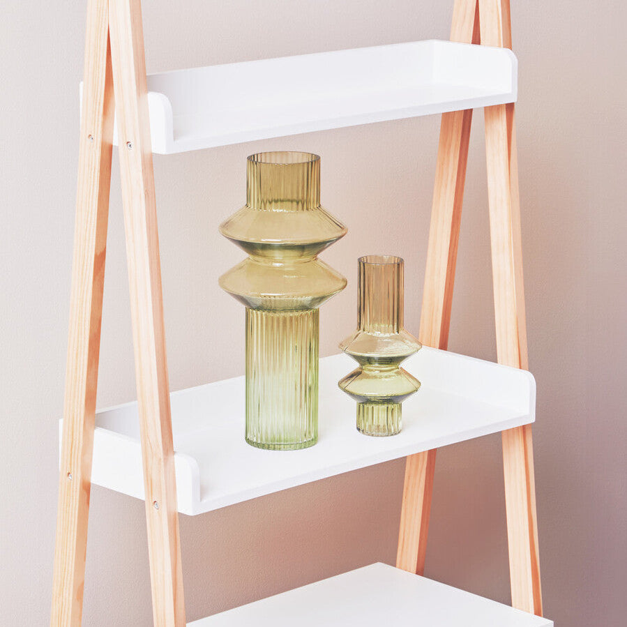 White shelf with wooden legs holding decorative vases against a plain background