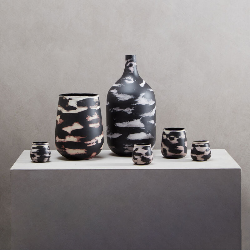Set of ceramic vases with abstract patterns on a gray background