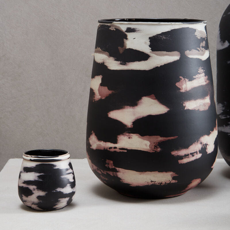 Black and white patterned ceramic vase on a gray background