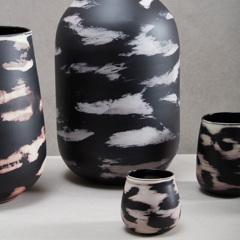 Black and white patterned ceramic vases on a gray background