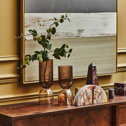 Decorative items on a wooden console table with a large mirror in the background.