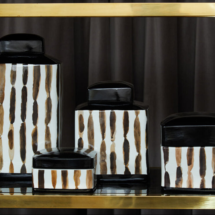 Set of decorative jars with a geometric pattern on a dark background