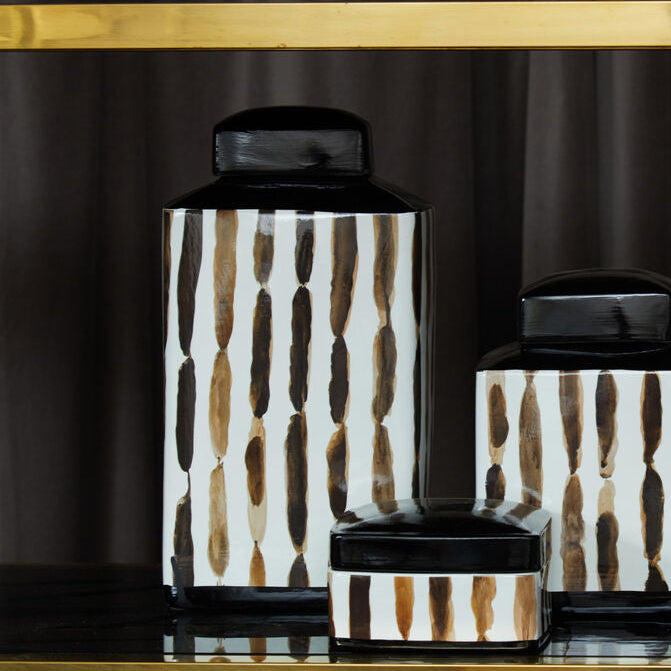 Set of decorative jars with a geometric pattern on a dark background