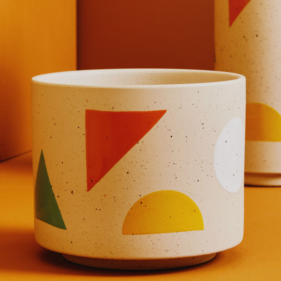 Ceramic pot with geometric shapes on a yellow background