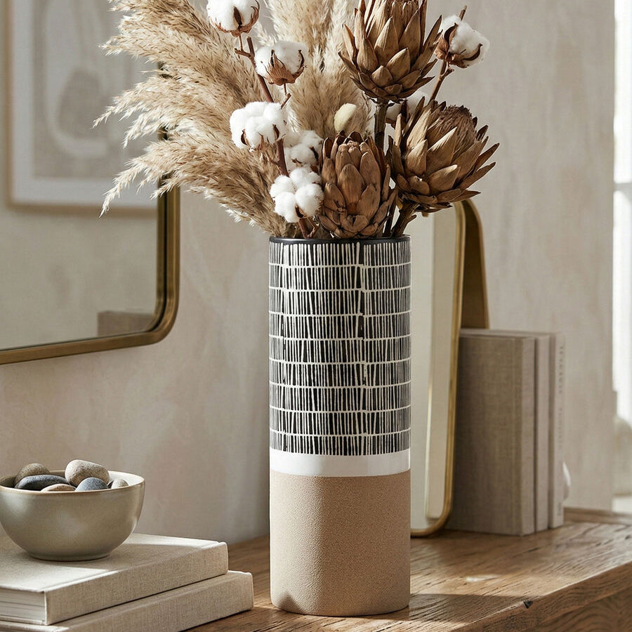 Decorative vase with dried flowers on a wooden table