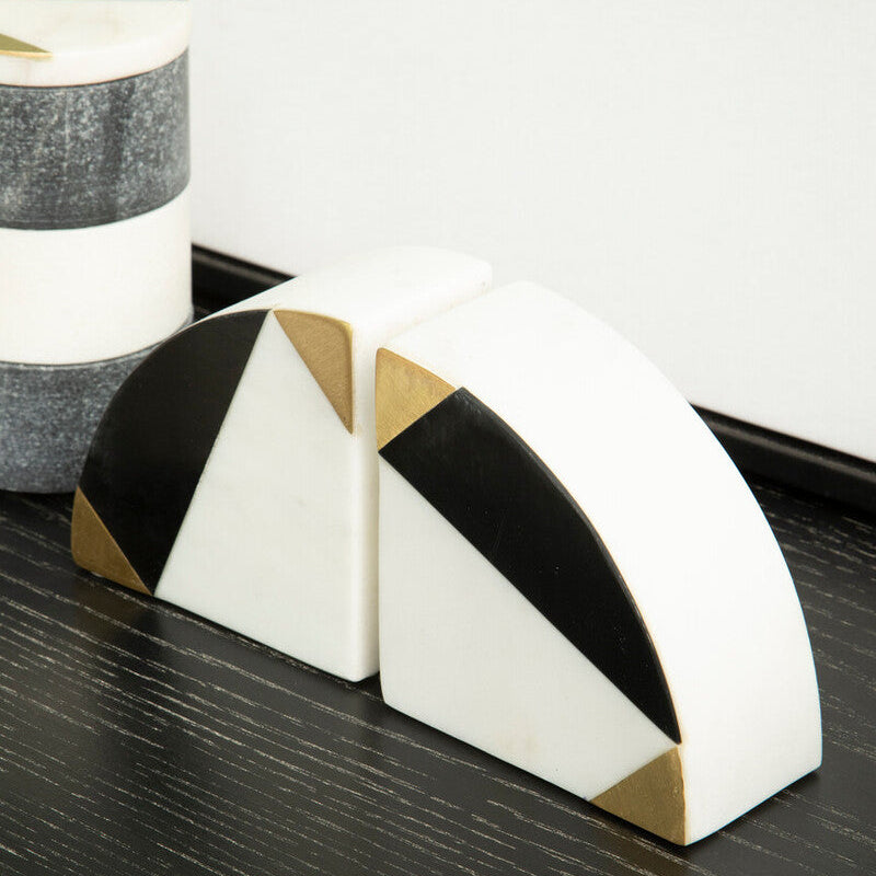 Decorative bookends with geometric design on a dark surface