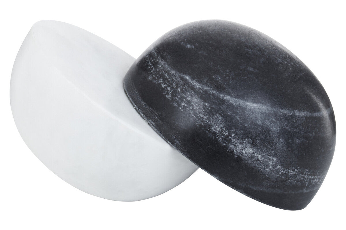 Black and white stone-like objects on a white background