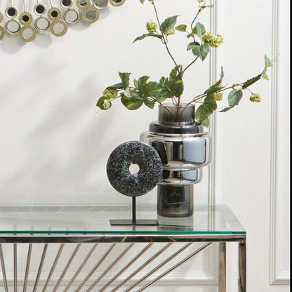 Decorative wall mirror with a glass console table below it.