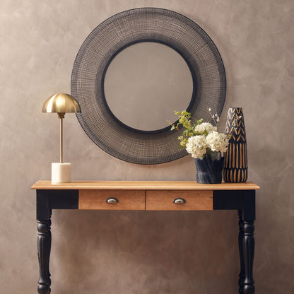 Wooden console table with decorative items against a beige wall