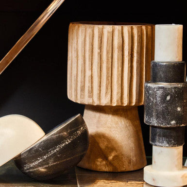 Decorative stone sculptures on a dark surface with a black background