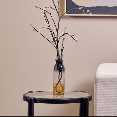 Modern living room with a white sofa, side table, and abstract wall art.