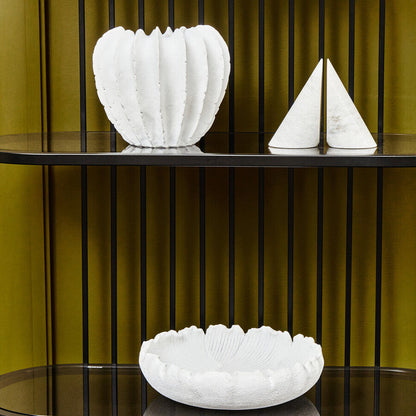 Decorative white vases on a black shelf against a green wall