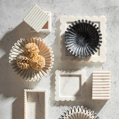 Set of ceramic kitchen utensils on a textured surface