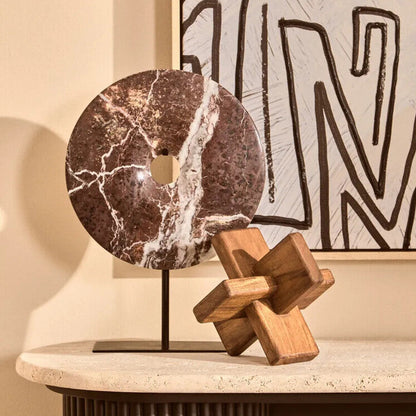 Decorative items on a table with abstract art in the background