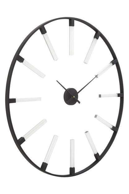 Decorative wall clock with black rim and white accents on a white background