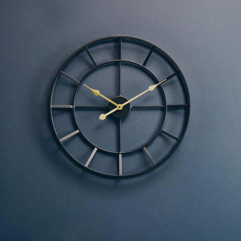 Black wall clock on a blue wall