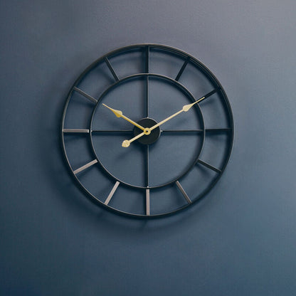 Black wall clock on a blue wall