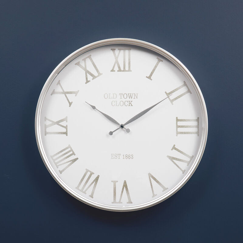 Wall clock with Roman numeral markers on a dark blue background