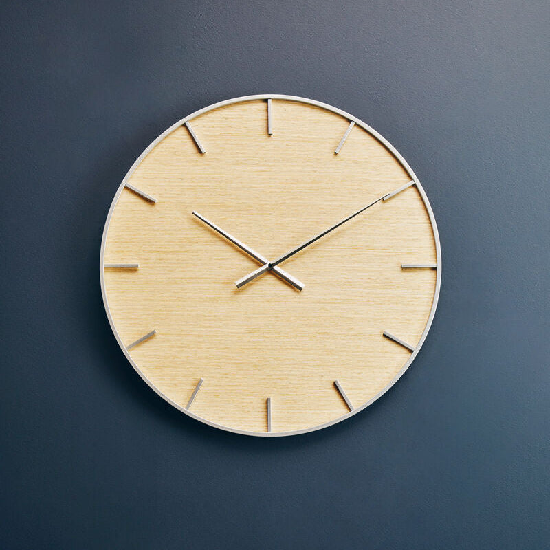 Wooden wall clock on a dark blue wall