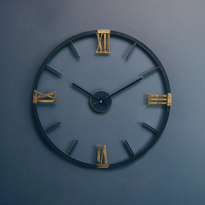 Decorative wall clock with gold accents on a blue wall