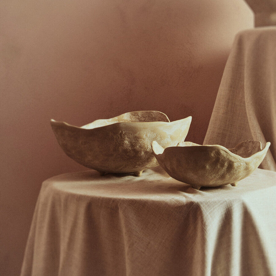 Two ceramic bowls on a table with a neutral background