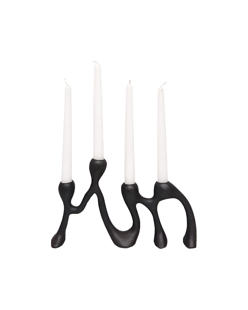 Black candle holder with four white candles on a white background